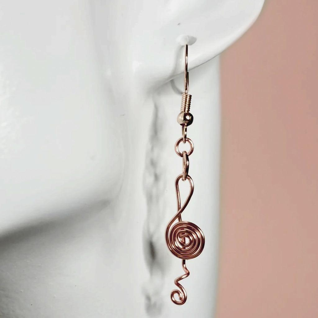 Treble clef spiral wire dangle earrings in rose gold tone