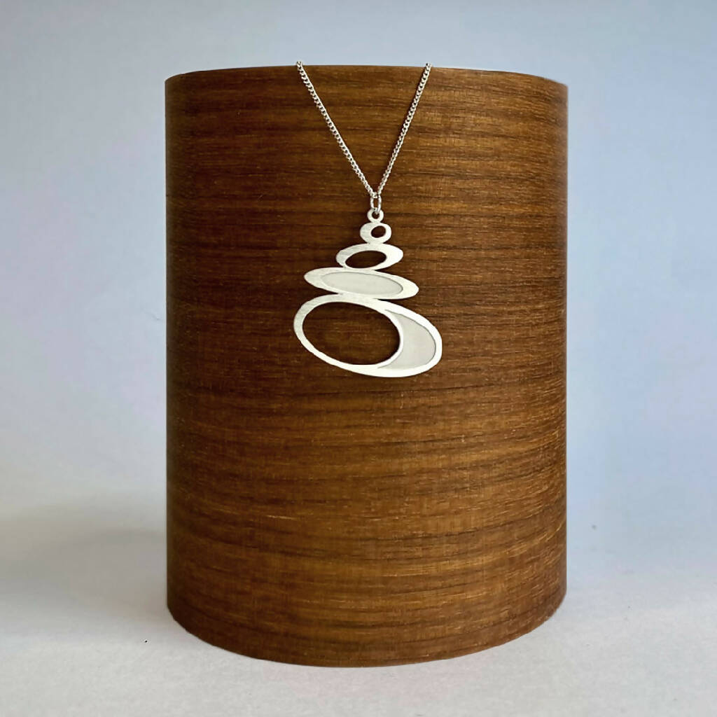 go-do-good-pebble-pendant-necklace-on wood