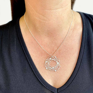 go-do-good-orbit-pendant-on-model